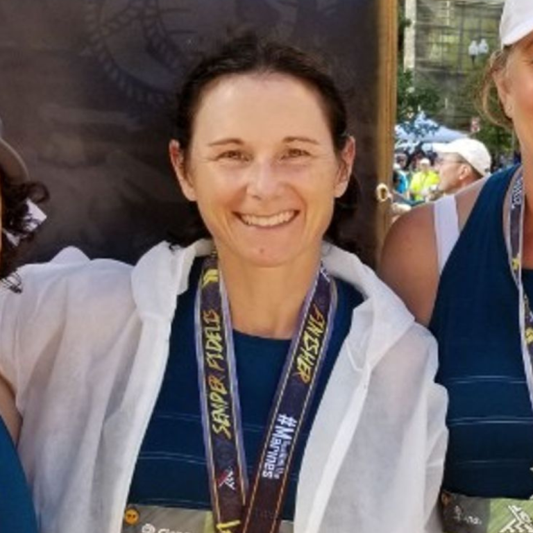 Kelly smiles with a marathon medal around her neck