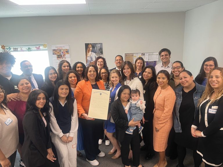 Lieutenant Kim Driscoll stands with staff and families of the Harbor Area Family Resource Center