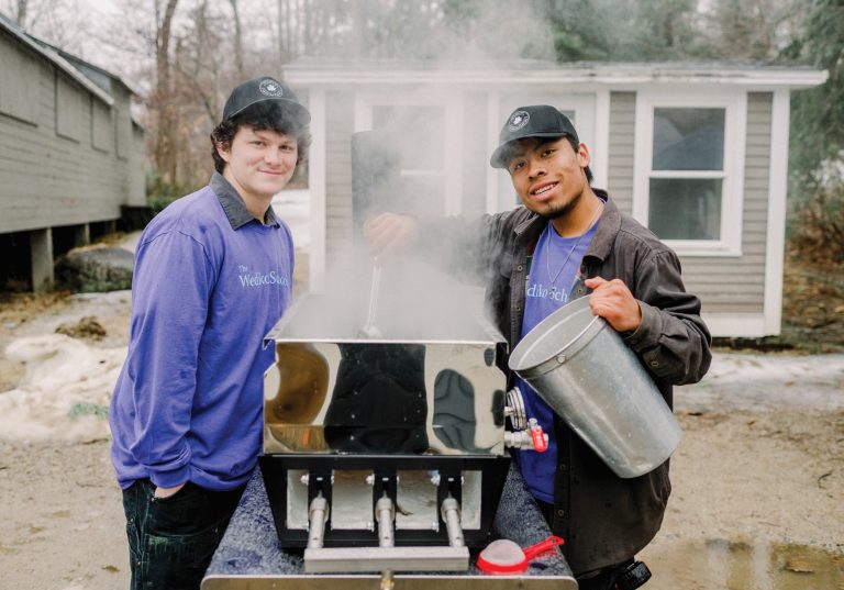 Joshua Stanton and Brendon Meyette stand over the boiler as they prepare maple syrup at The Wediko School